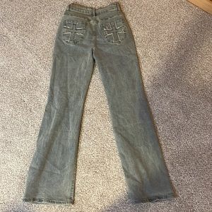 high waisted flare legged jeans with cross design